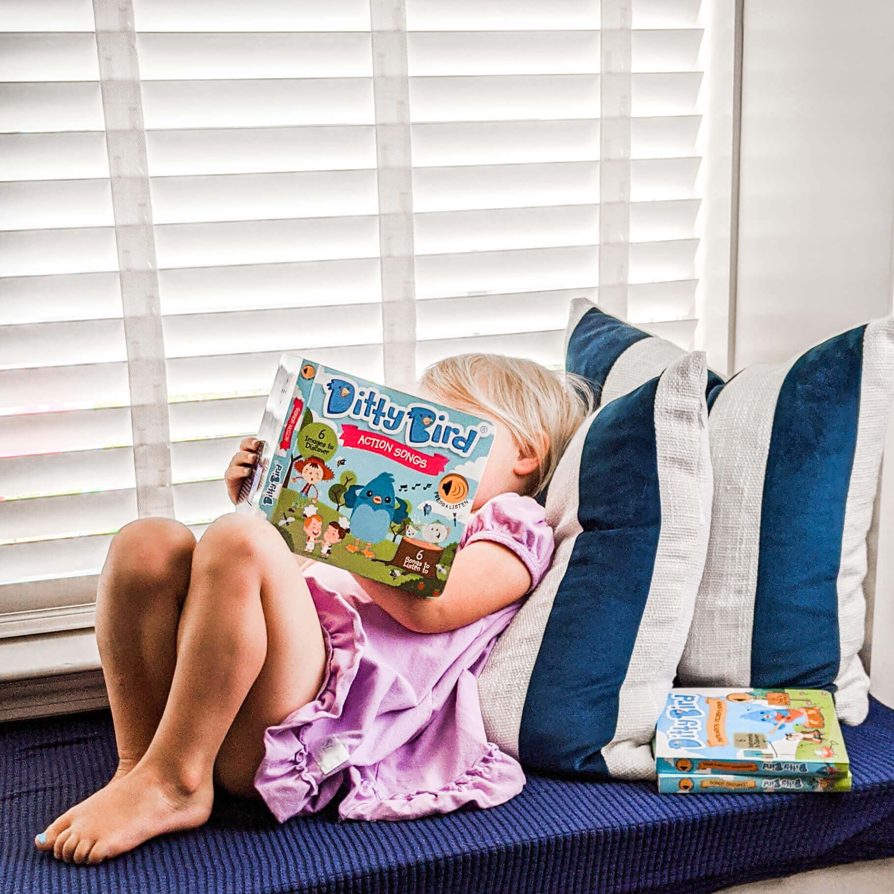 Toddler reading Ditty Bird's Sound book